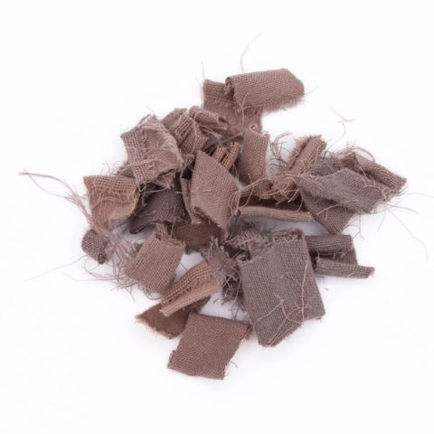 A heap of frayed fabric scraps in dusty mauve, cut into small rectangles with loose threads bristling from every edge.