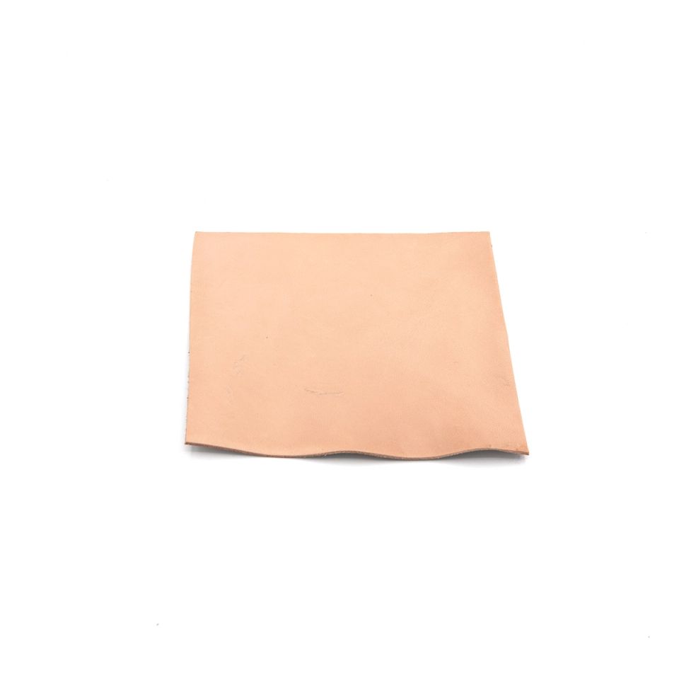A square of chrome-tanned bison leather in soft blush pink, one corner lifting to show its suede-like reverse.