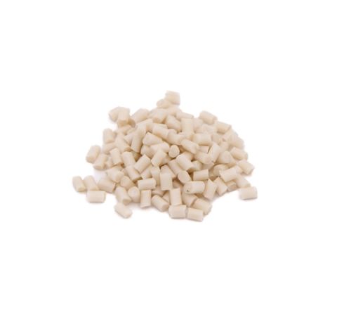 A small heap of short cylindrical plastic pellets in creamy off-white, each cut flat at both ends.