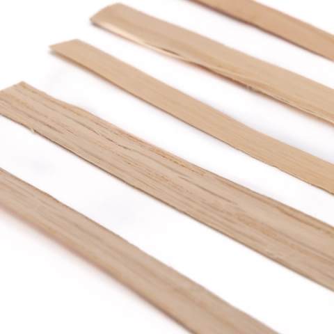 Five flat strips of rivercane laid in parallel at an angle, pale straw-coloured, their surfaces showing fine lengthwise fibres.