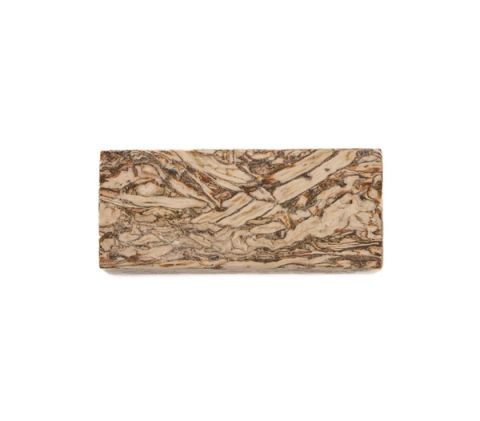 A rectangular block of engineered hemp lumber, its face a swirling marbled pattern of cream and dark brown running lengthwise.
