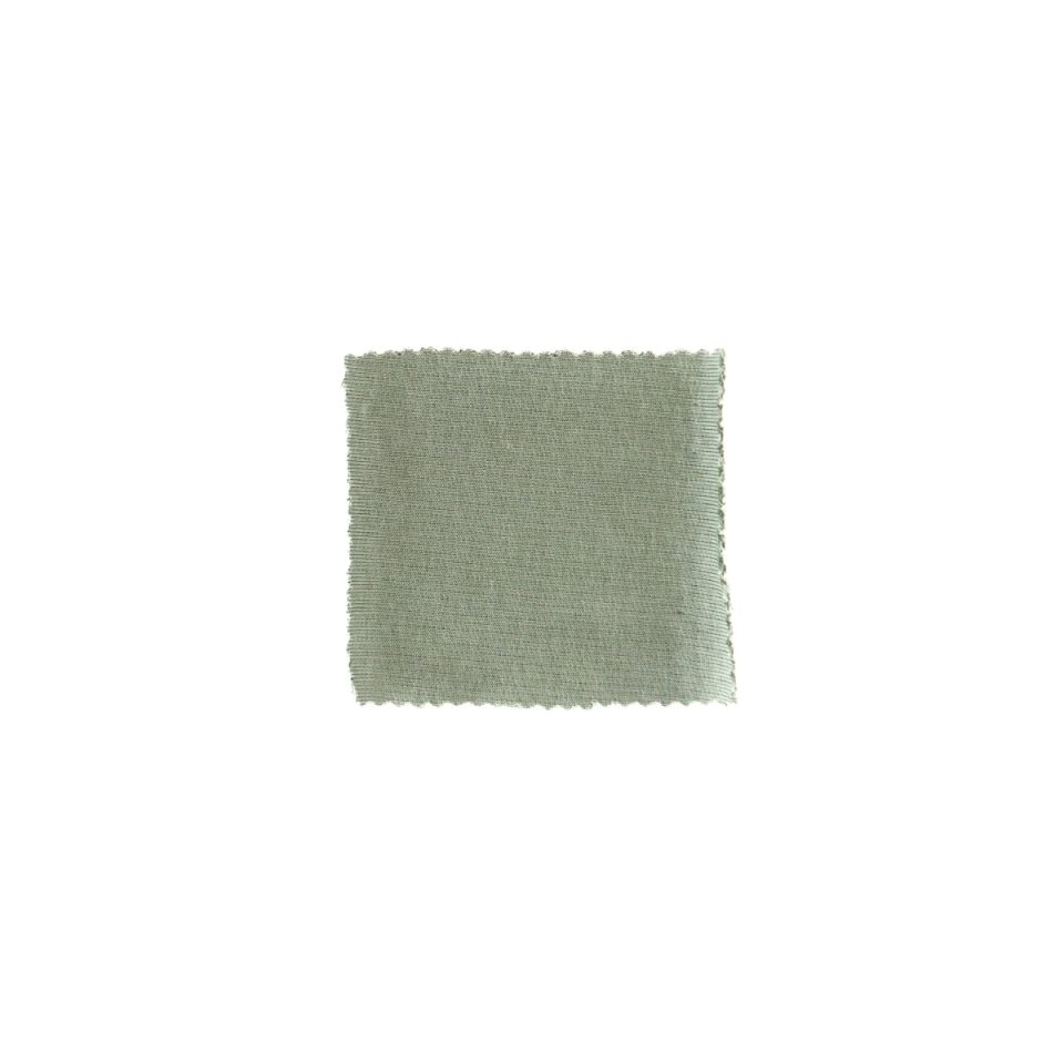 A small square swatch of sage-green knit with a smooth, close, faintly diagonal surface and lightly scalloped edges.
