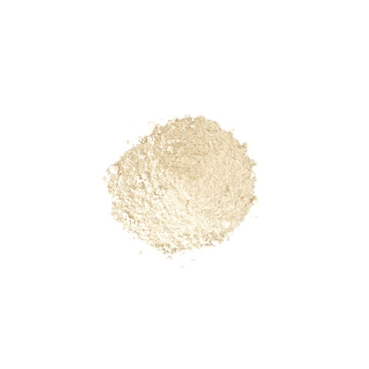 A smaller, paler heap of the powder, its grains fine and cream-coloured rather than the olive-khaki of the main shot.