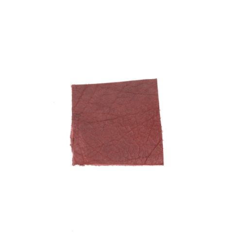A square of vegetable-tanned cowhide in deep oxblood red, its surface faintly veined with a natural grain.