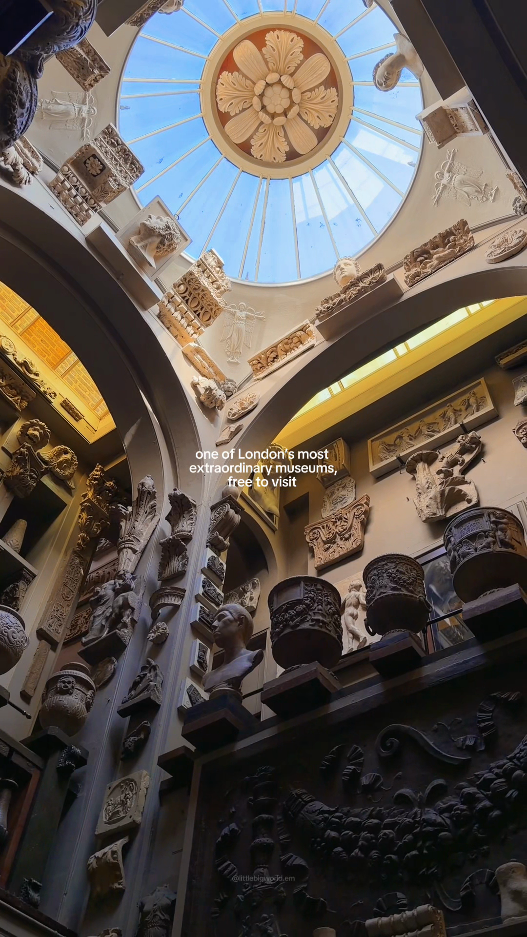 A small skylit dome above sculptural casts and architectural fragments.