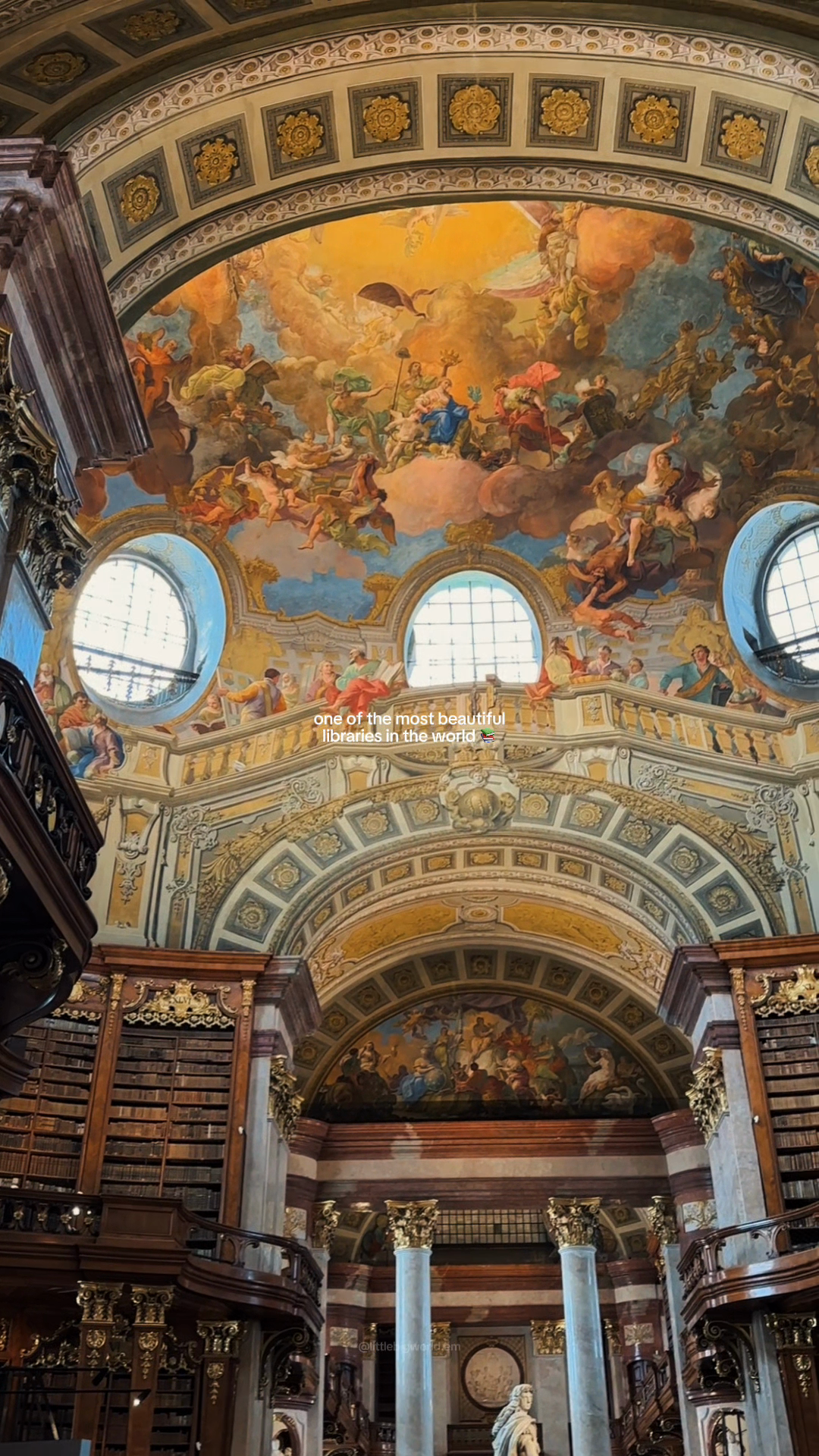 Baroque library shelves and a frescoed dome.
