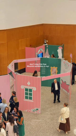 An exhibition constructed as colorful open book pages inside Brooklyn Central Library.