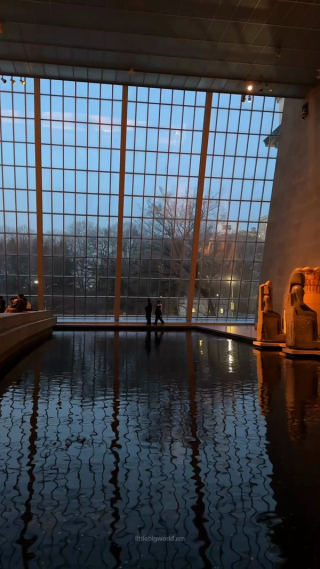The reflecting pool and tall glass wall surrounding the Temple of Dendur at The Met.