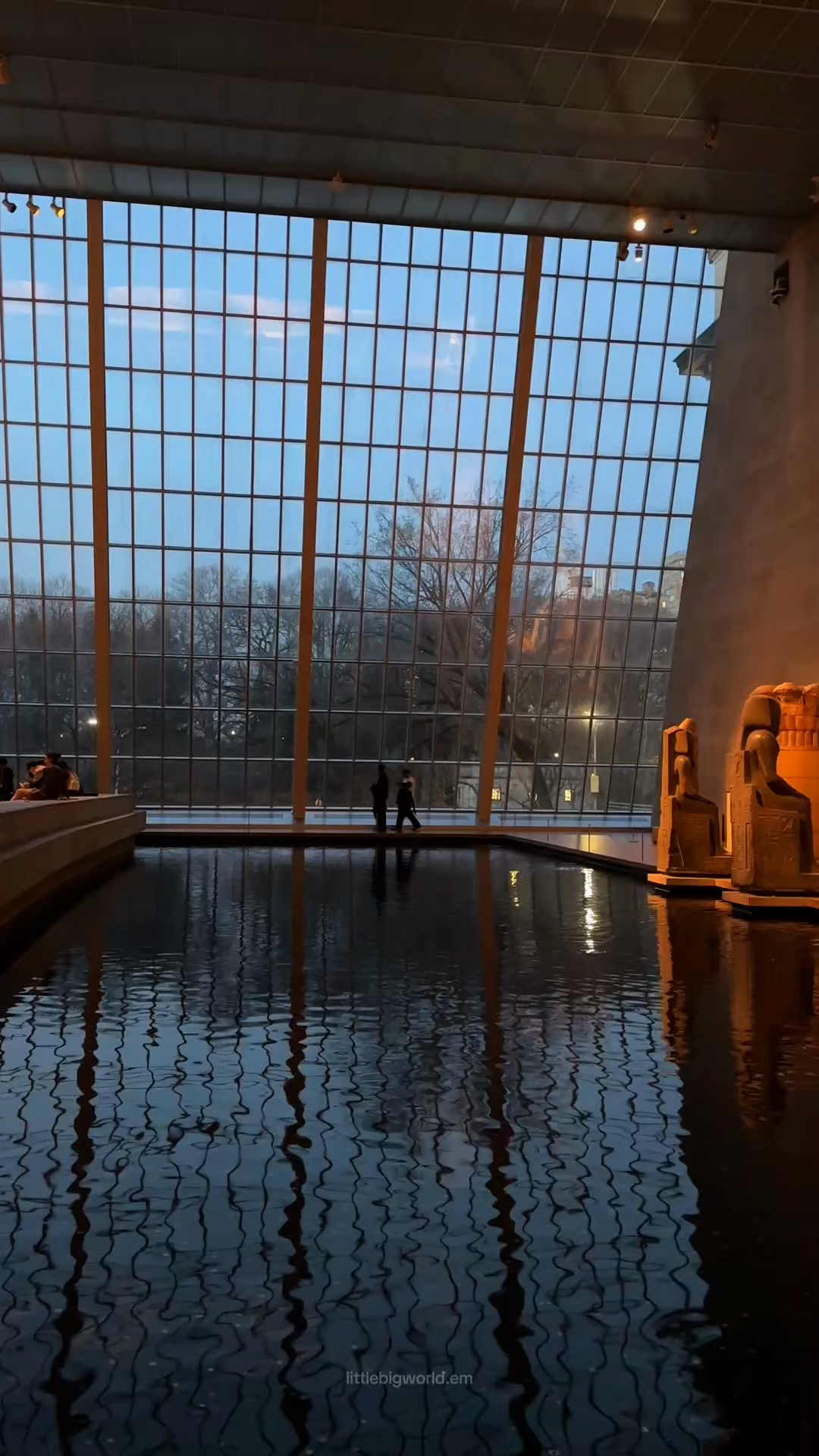 The reflecting pool and tall glass wall surrounding the Temple of Dendur at The Met.