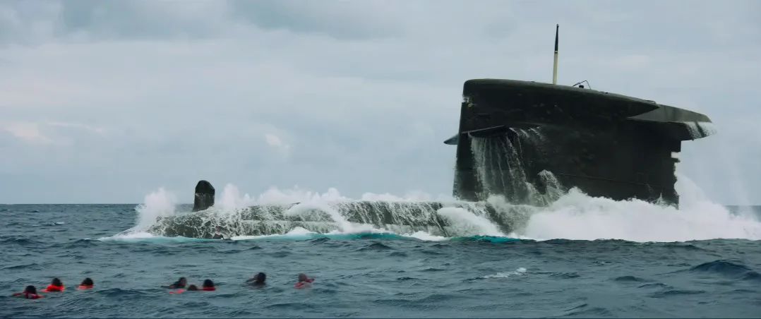A submarine surfaces in a turquoise sea.