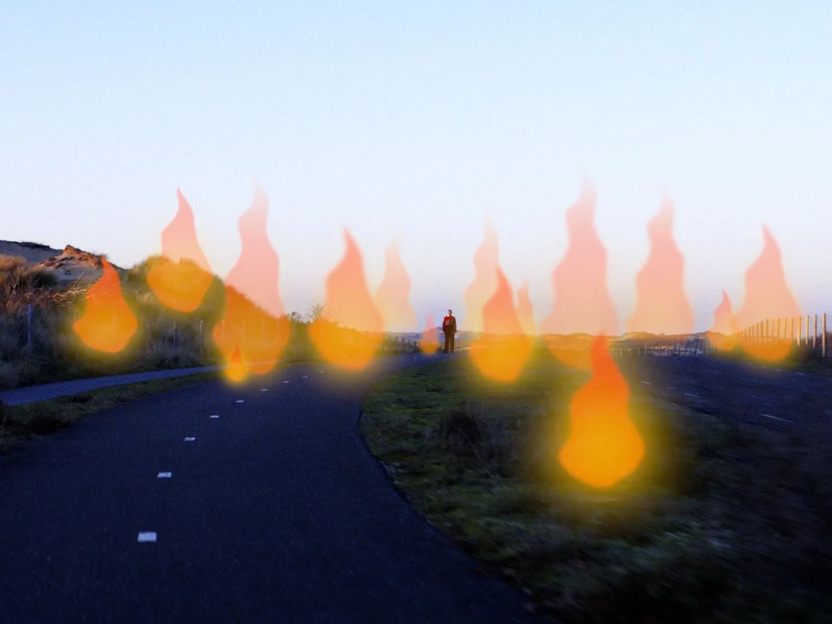 Animated flames hover over a cycle path through the dunes at dusk.