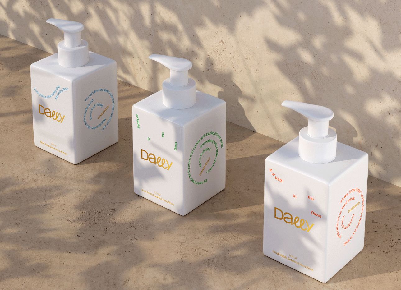 Three white Dally soap dispensers on a concrete wall.