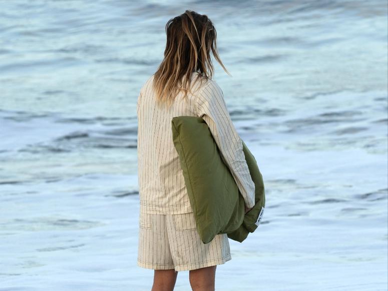 Girl with pajamas looking at the ocean