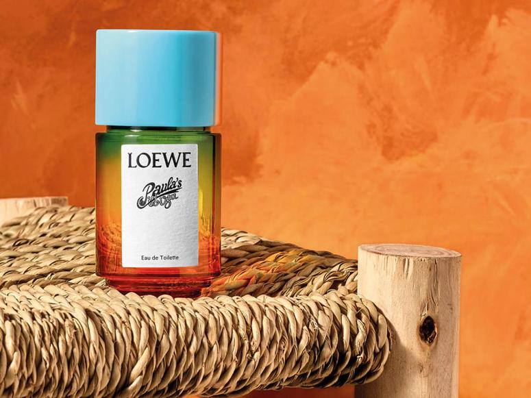 A bottle of Loewe perfume on a straw chair