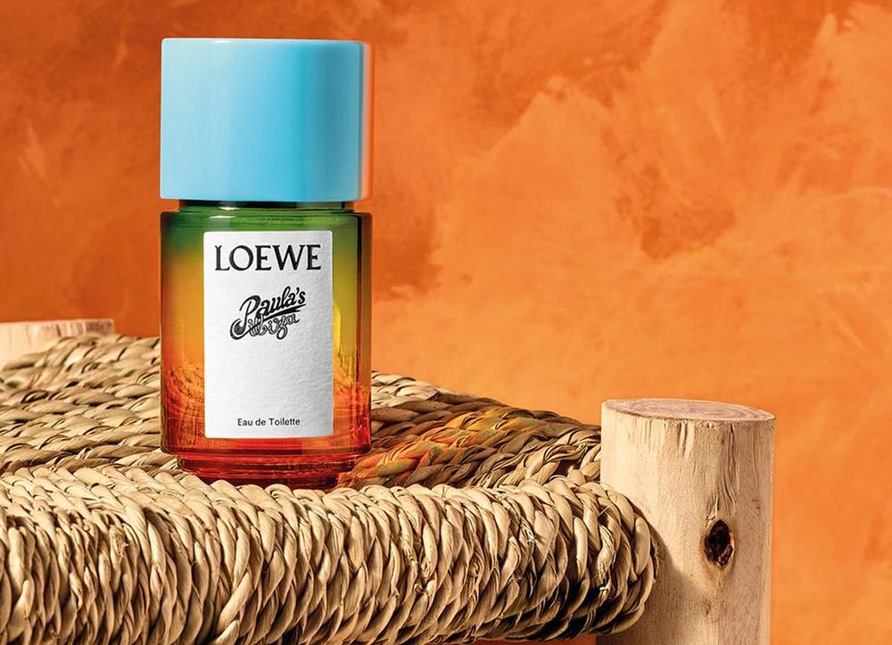 A bottle of Loewe perfume on a straw chair