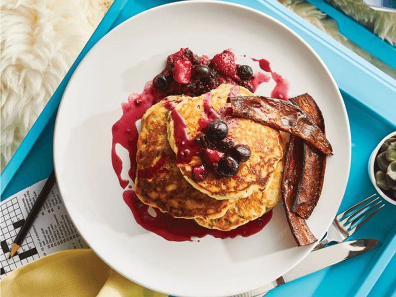 Pancakes with bacon on a white plate