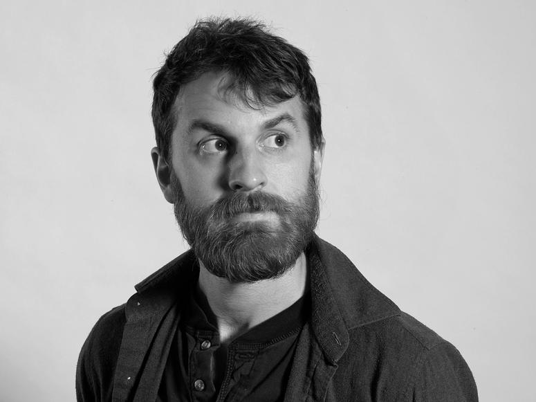 Pat McCusker looking off and to the left.