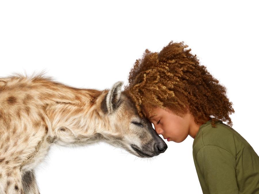 Photo of child with hyena from The Lion's Share campaign