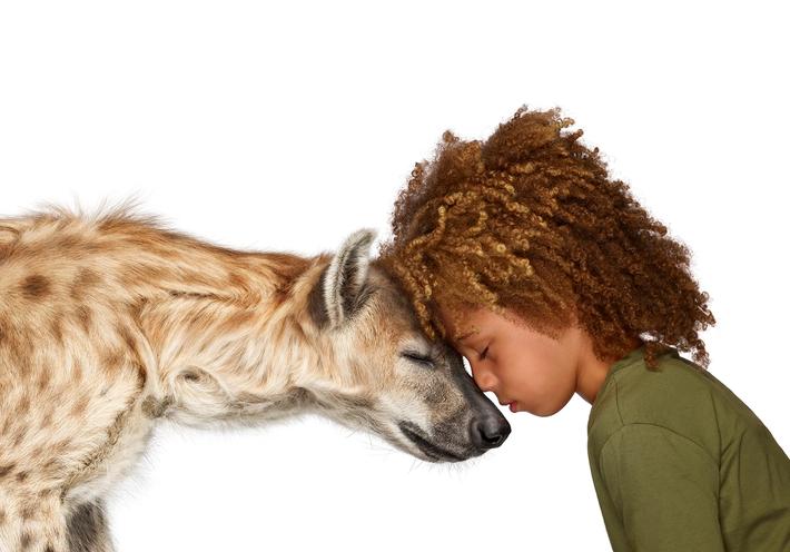Photo of child with hyena from The Lion's Share campaign