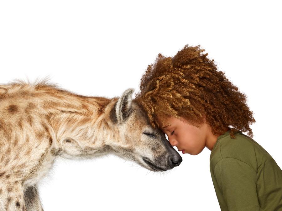 Photo of child with hyena from The Lion's Share campaign