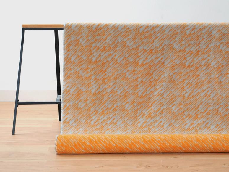 A striated orange and white throw over a display hitch.