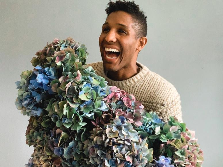 Kristen Griffith-VanderYacht laughing while holding a large bouquet.