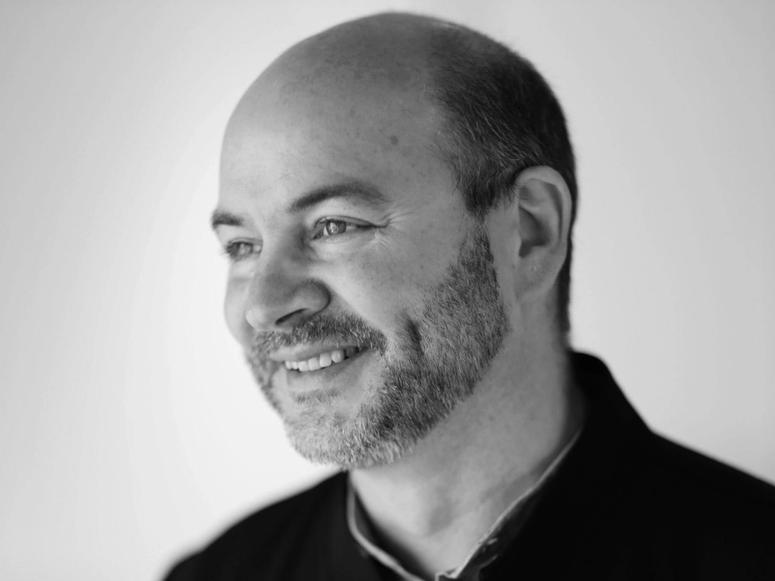 Black and white photo of Snøhetta co-founder Craig Dykers