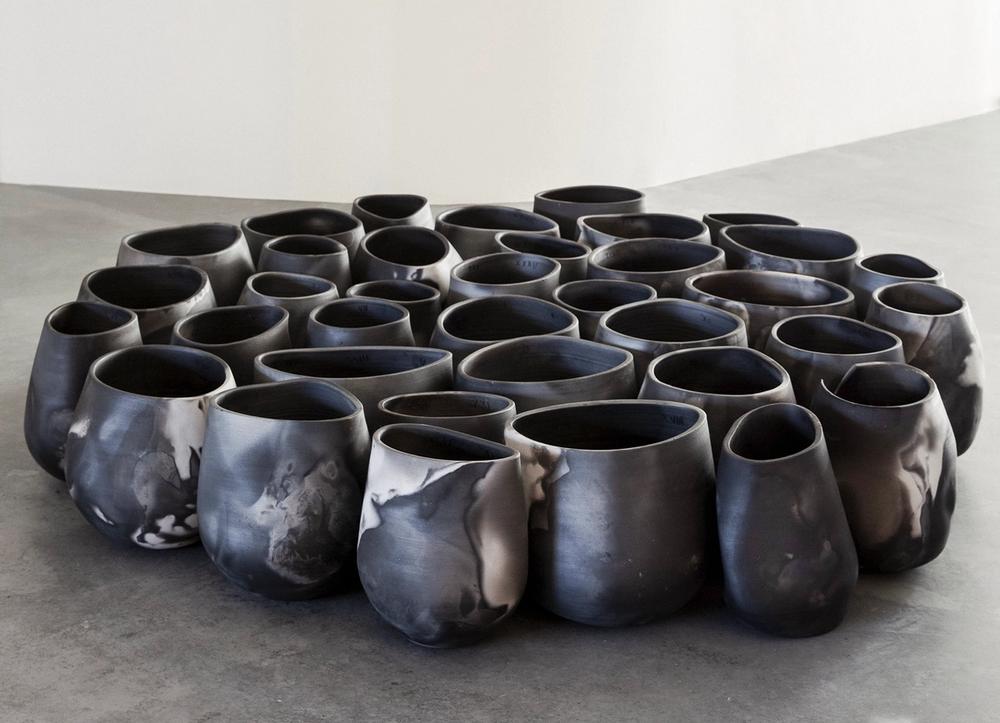 Marbled black tondela vessels in a gallery.