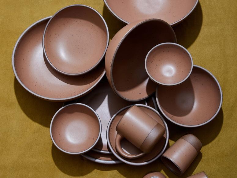 Brown bowls on a dark yellow background.