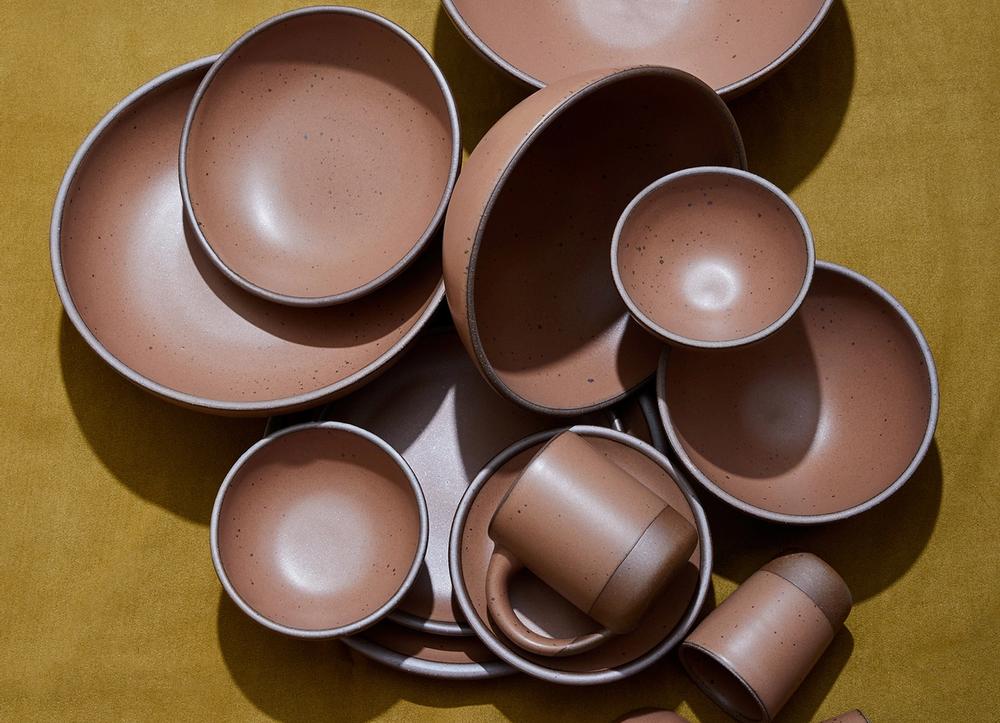 Brown bowls on a dark yellow background.