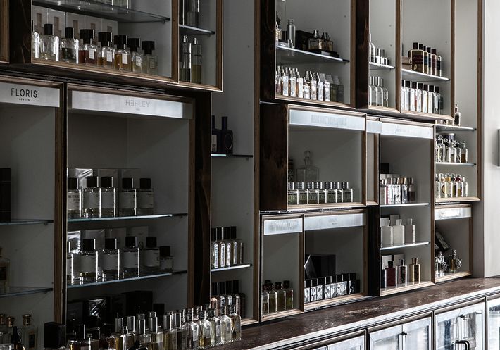 The interior of a fragrance boutique, with many bottles lined up on shelves.