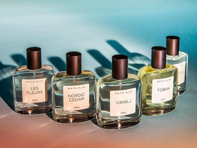 Five bottles of perfume on an ombre table