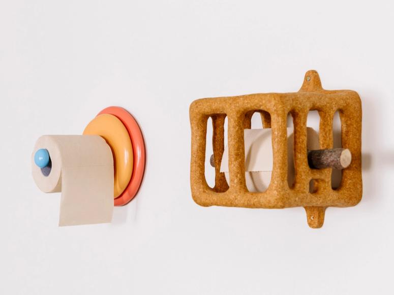 Two sculptural toilet paper holders.