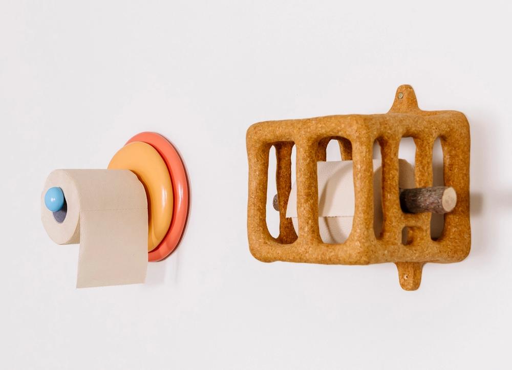 Two sculptural toilet paper holders.