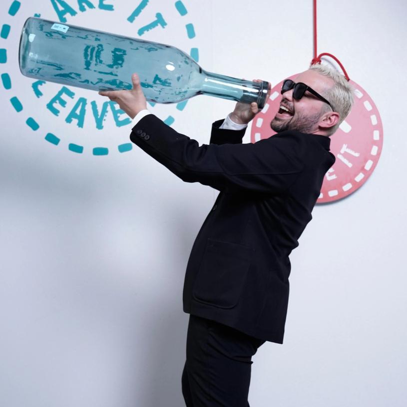 Rodolfo Agrella, founder and creative director at Rodolfo Agrella Design Studio, with the giant blue glass bottle he decided to leave behind at “Take It or Leave It.” (Photo: Mattia Gargioni)