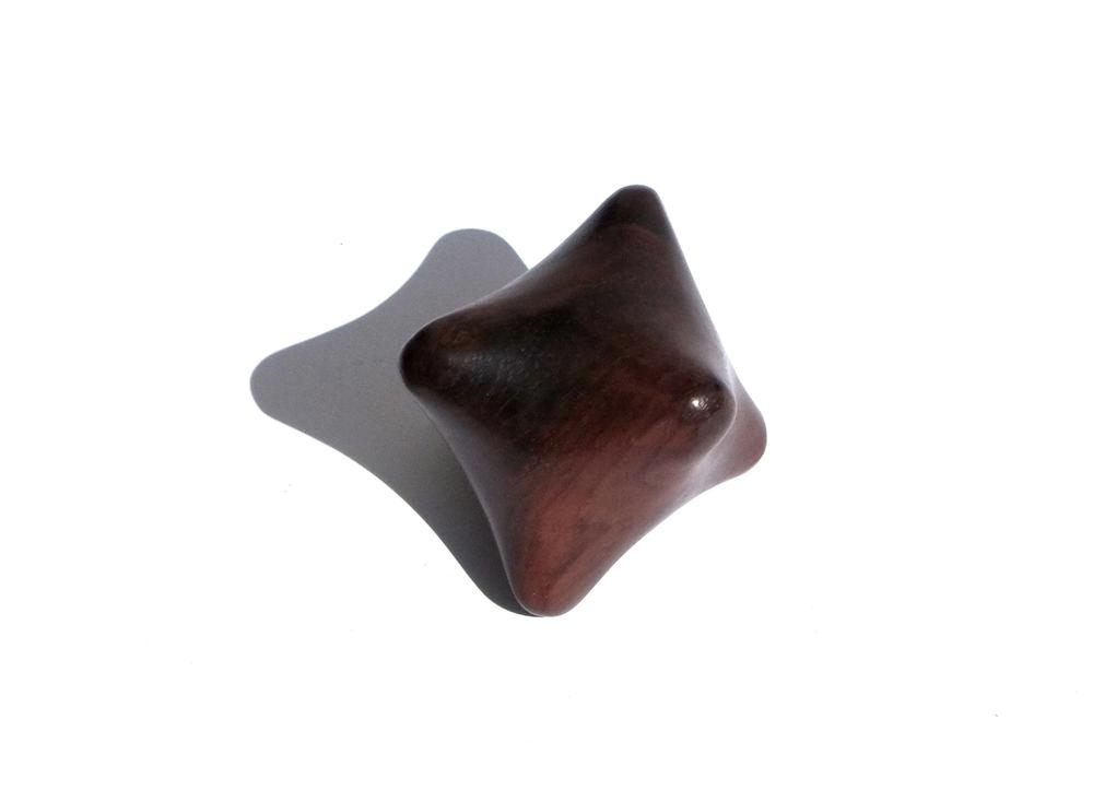 A wooden polygonal massage tool.
