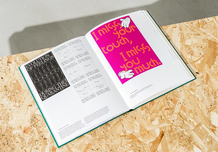 The book “Designers Against Coronavirus” open on a wood table