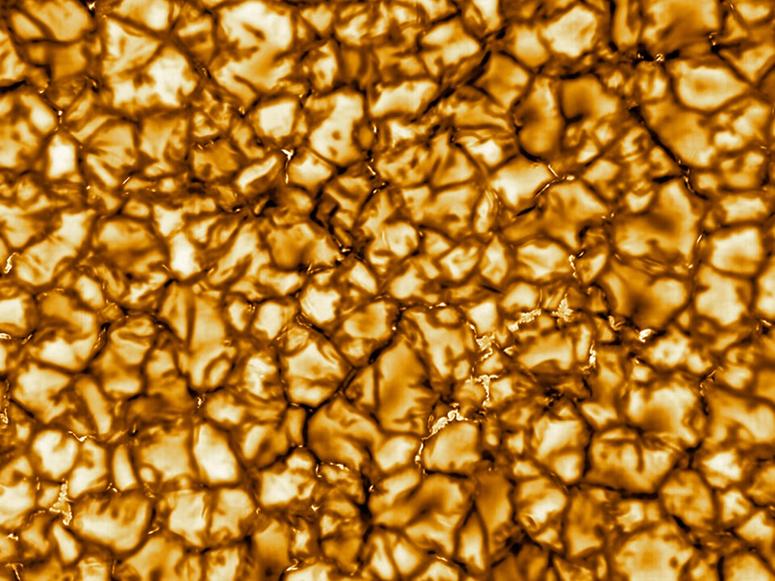 A close-up photo of the sun's golden surface.
