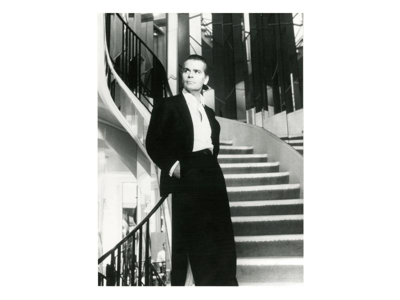 Lagerfeld in 1983, upon being named artistic director of Chanel, posing on the mirrored staircase at 31, rue Cambon where Gabrielle Chanel once stood. (Photo: Helmut Newton. Courtesy Chanel and Harper Books)