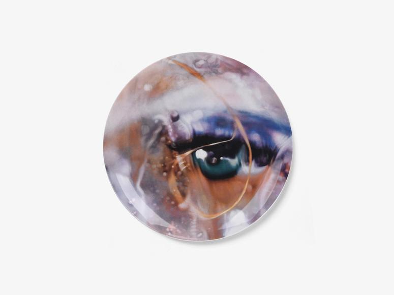 A dinner plate depicting an image of a blue eye