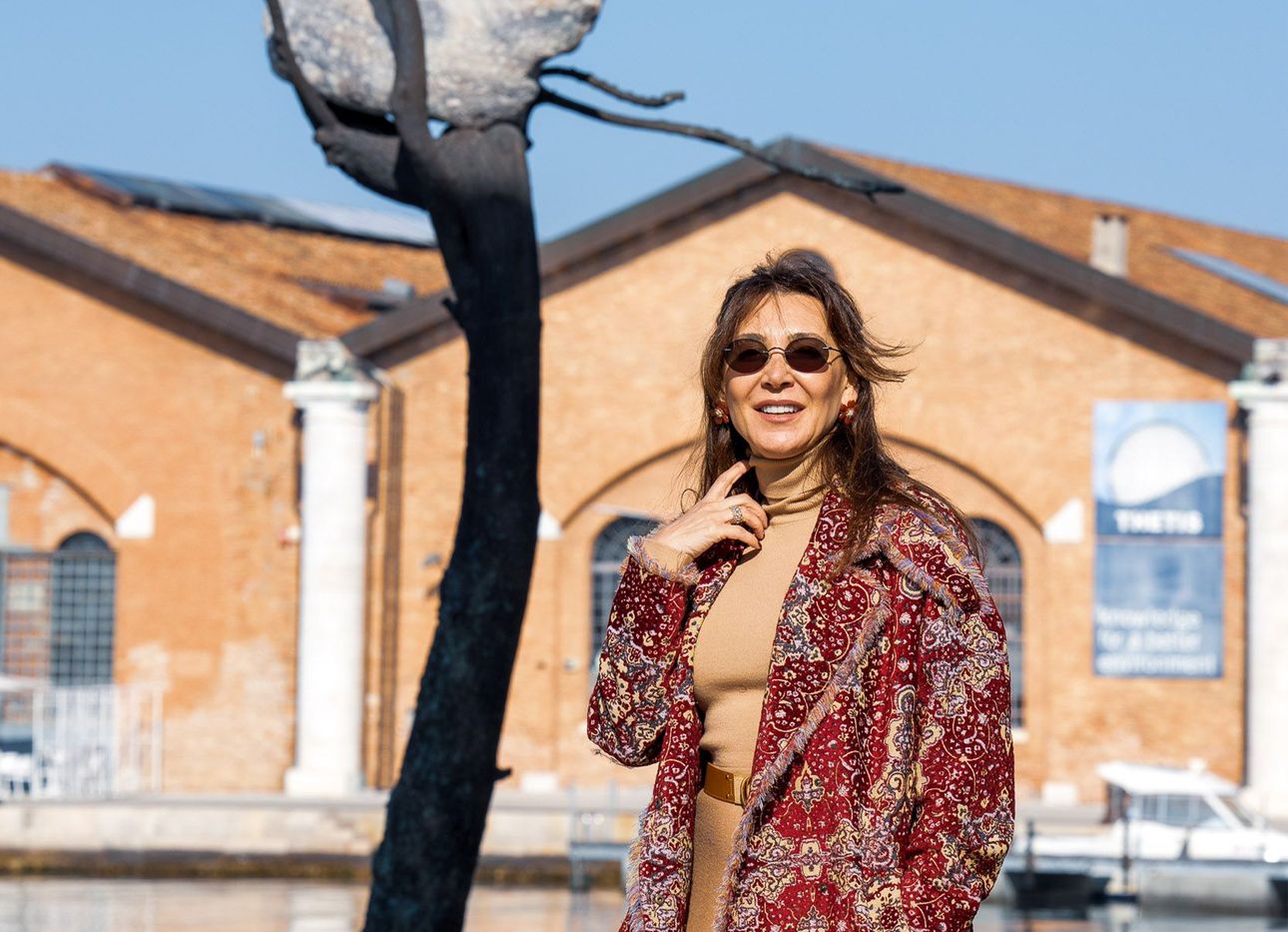 Vuslat Doğan Sabancı in front of artist Giuseppe Penone’s sculpture “Idee di Pietra–Olmo,” commissioned by the Vuslat Foundation for the 2021 Venice Architecture Biennale. (Photo: Enrico Fiorese)