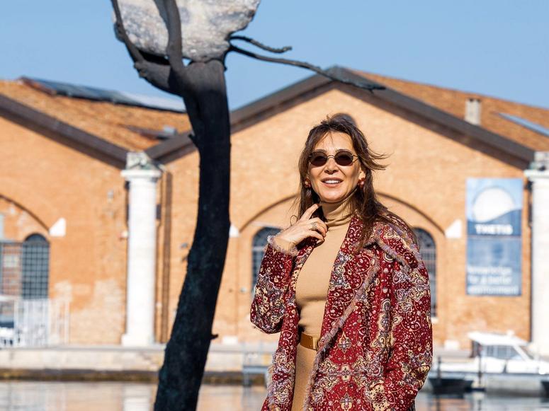 Vuslat Doğan Sabancı in front of artist Giuseppe Penone’s sculpture “Idee di Pietra–Olmo,” commissioned by the Vuslat Foundation for the 2021 Venice Architecture Biennale. (Photo: Enrico Fiorese)