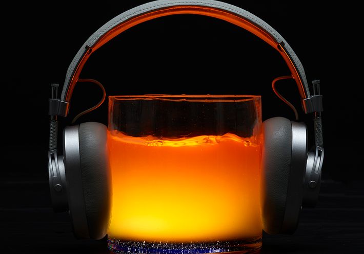 Headphones on a glass of liquid.