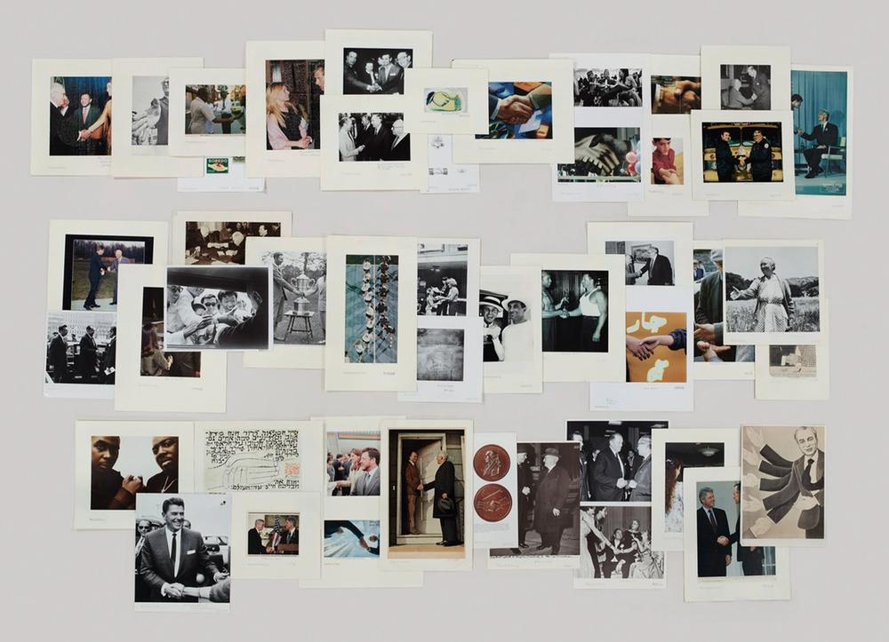 A photograph of images from the Picture Collection’s Handshaking folder by Taryn Simon, featured in the exhibition “The Color of a Flea’s Eye.”
