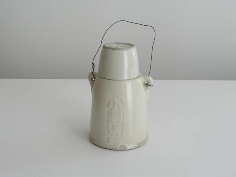 A white ceramic kettle on a white background.