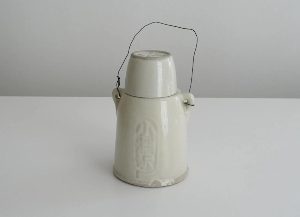 A white ceramic kettle on a white background.
