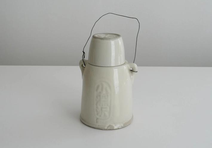 A white ceramic kettle on a white background.