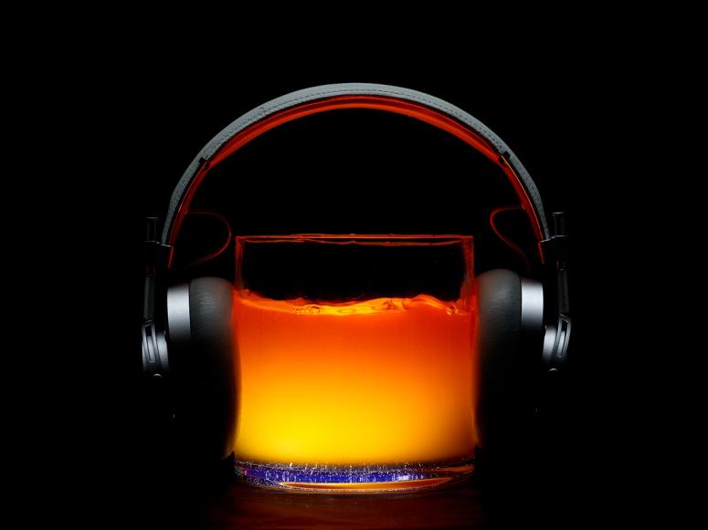 Headphones on a glass of liquid.