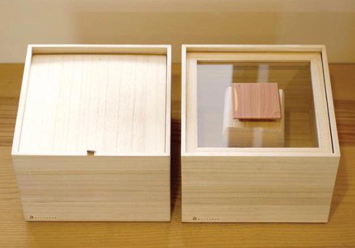 Two wooden boxes, one with a clear top and one with a wooden top.