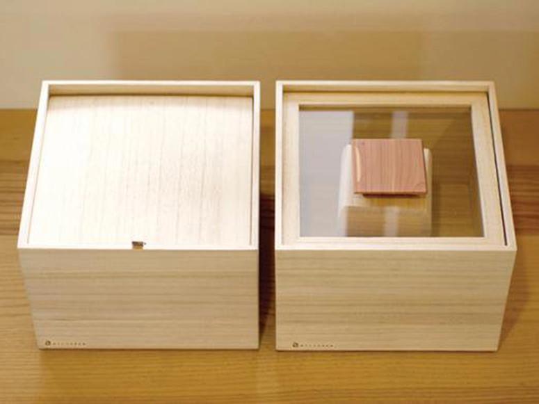 Two wooden boxes, one with a clear top and one with a wooden top.